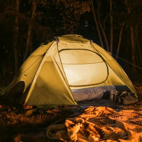 Glowing tent in a dark forest setting