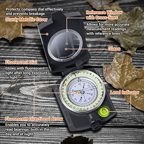 Military compass with features labeled including sturdy metallic cover, reference window, fluorescent dial, glass, level indicator, and directional arrow.